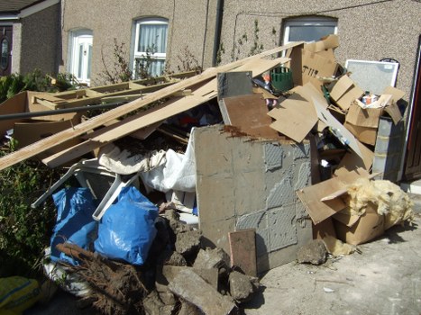 Workers sorting materials at a local West London transfer station